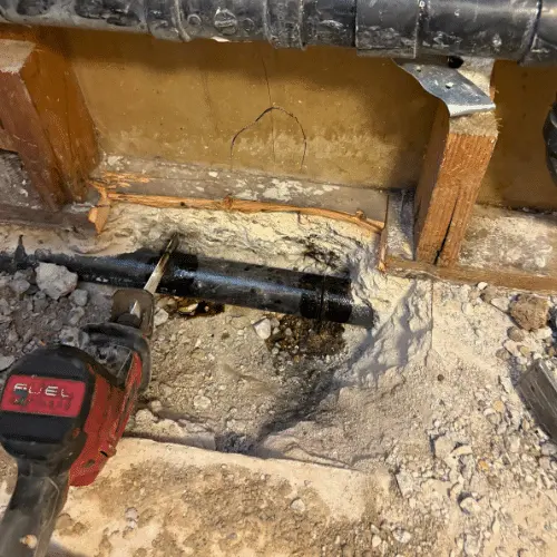 Cast-iron drain exposed through an opening in the concrete floor