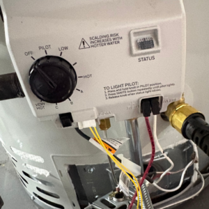 Gas valve and supply lines on a Utah water heater — typical components on a fair-priced repair quote
